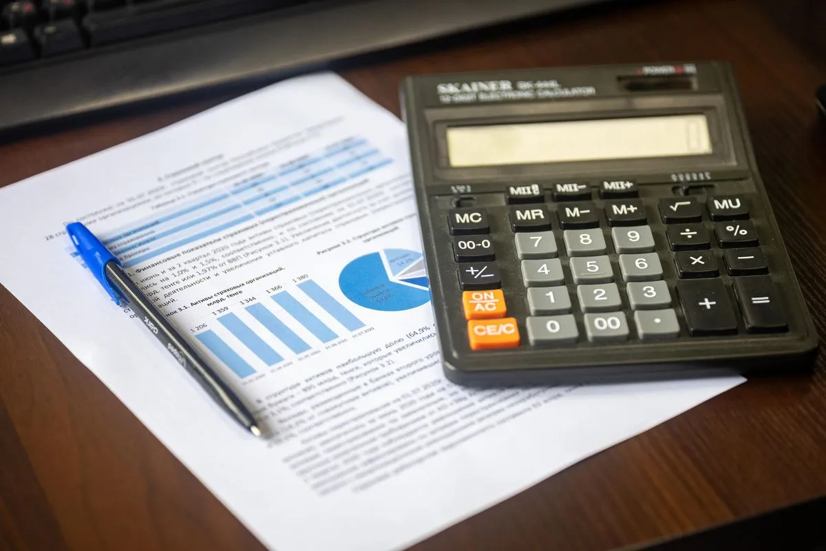 Calculator and financial documents on an office desk