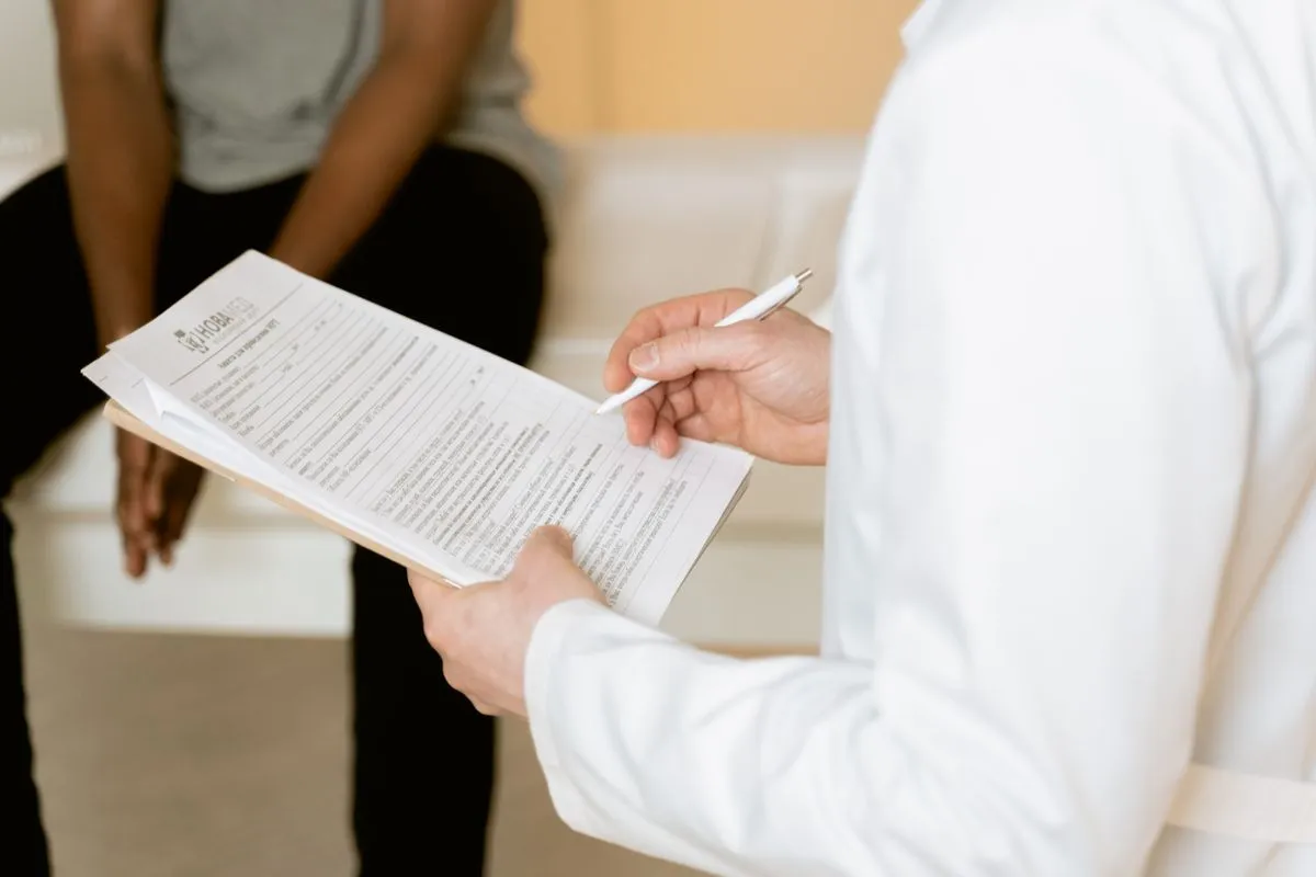 A healthcare professional reviewing a consultation form