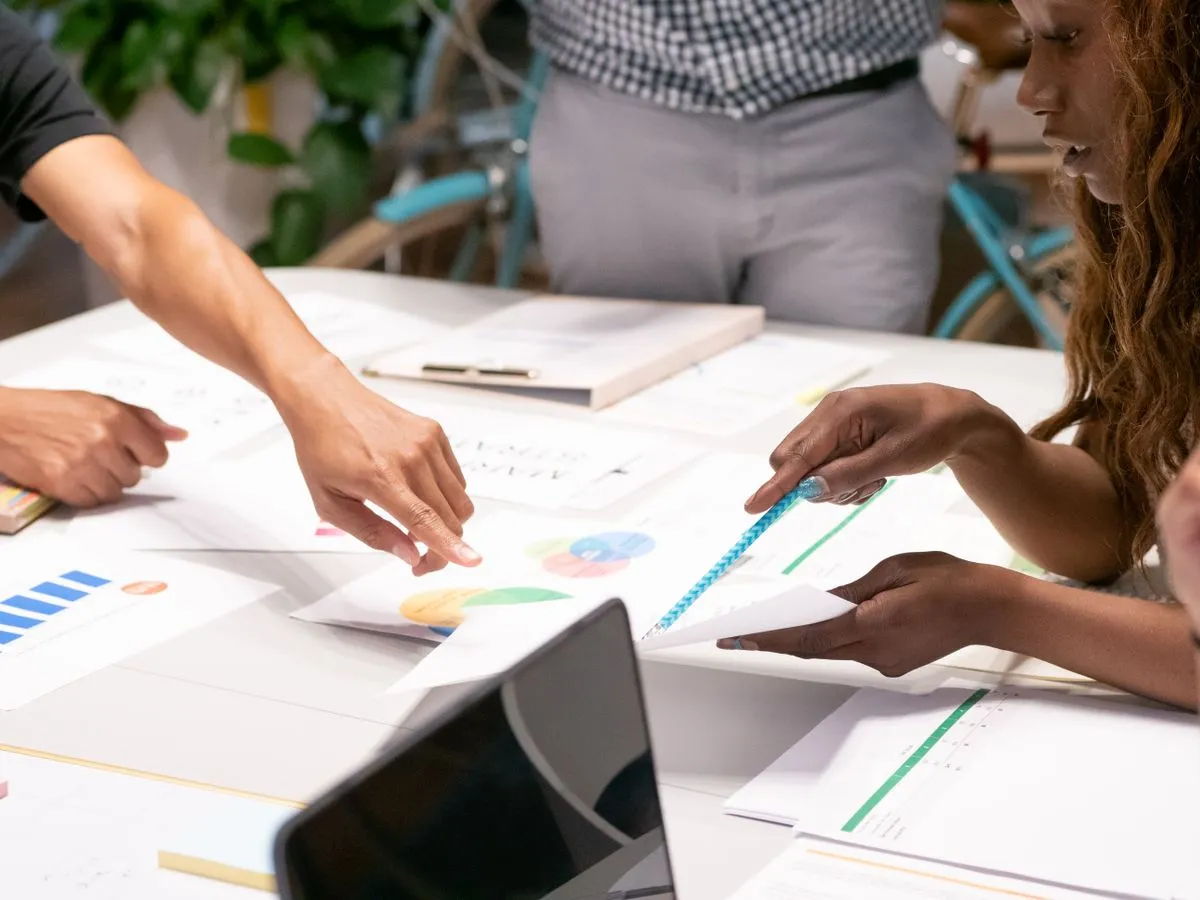 A creative team reviewing campaign charts and documents