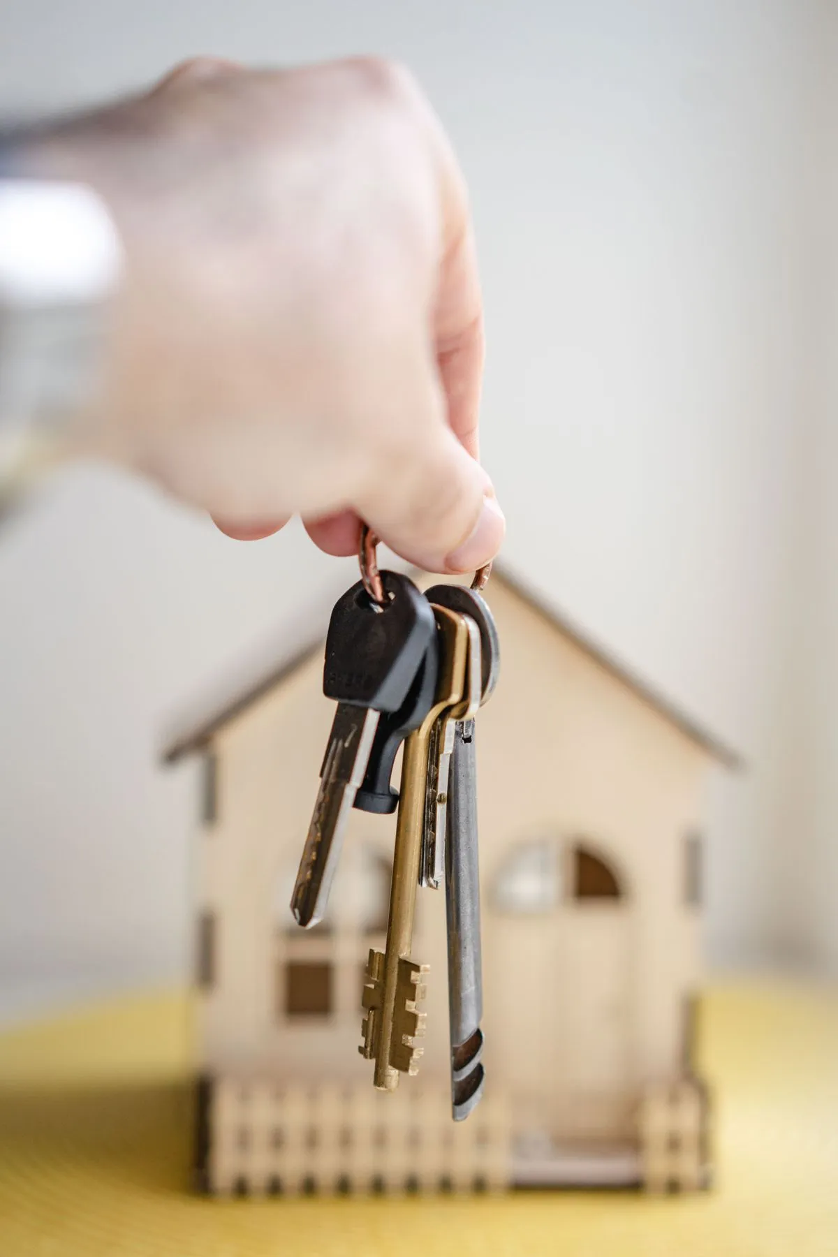House keys held in front of a property model