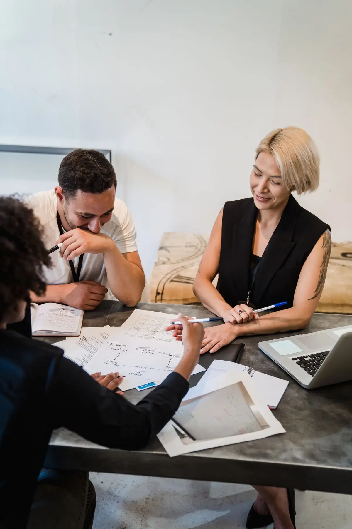 Colleagues reviewing plans around an office table