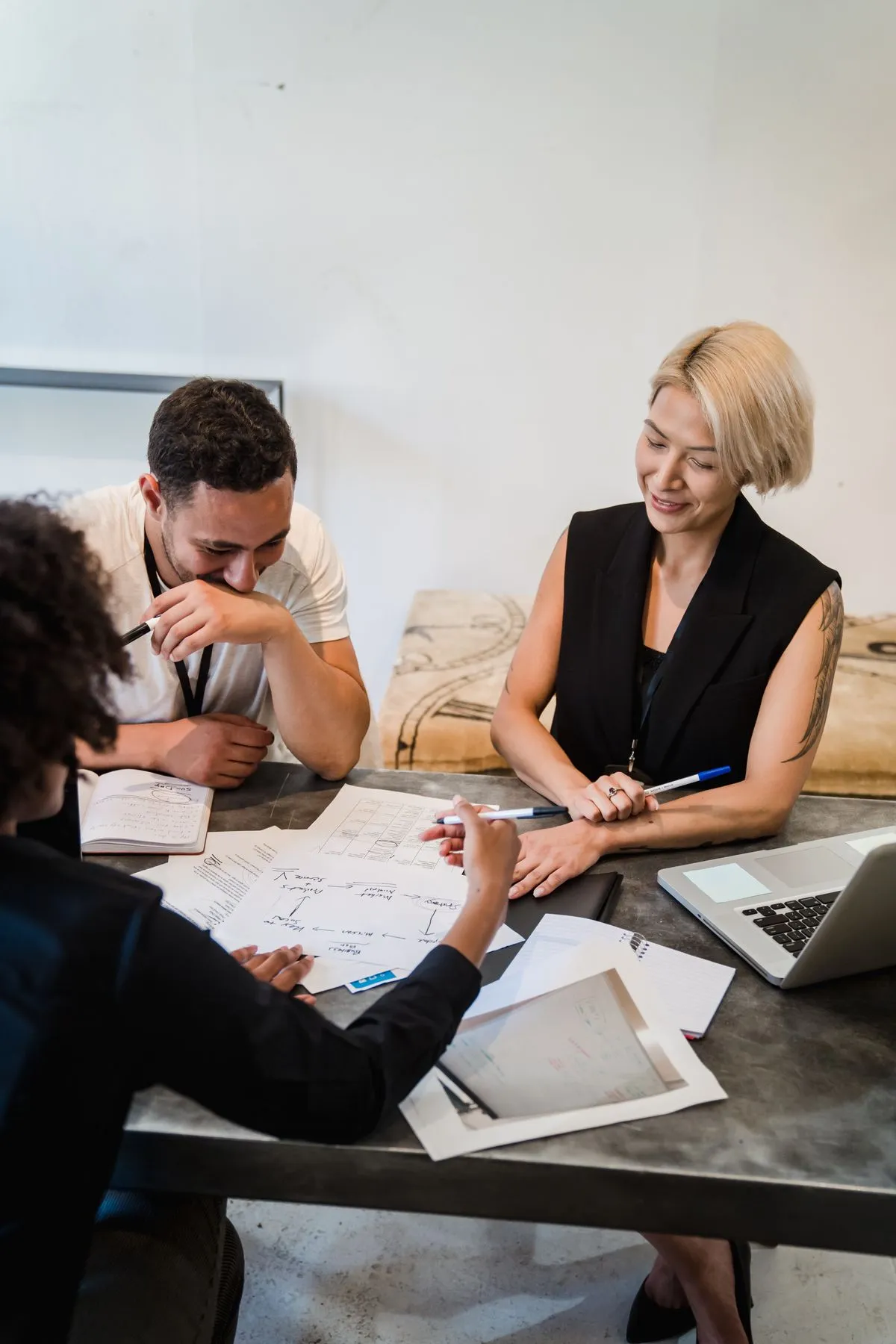 Colleagues reviewing plans around an office table