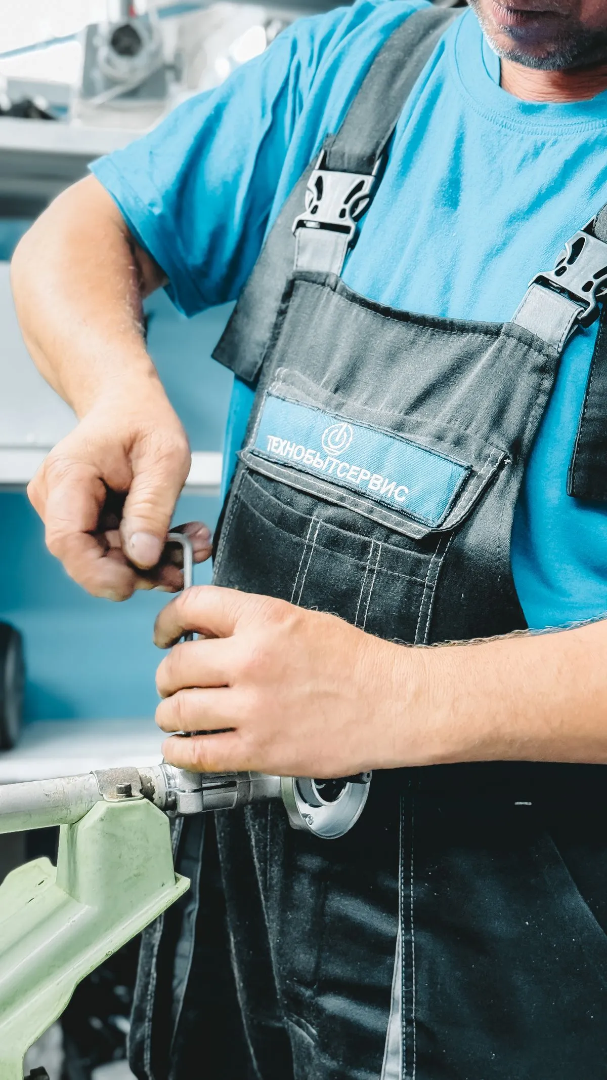 A tradesperson repairing a pipe assembly
