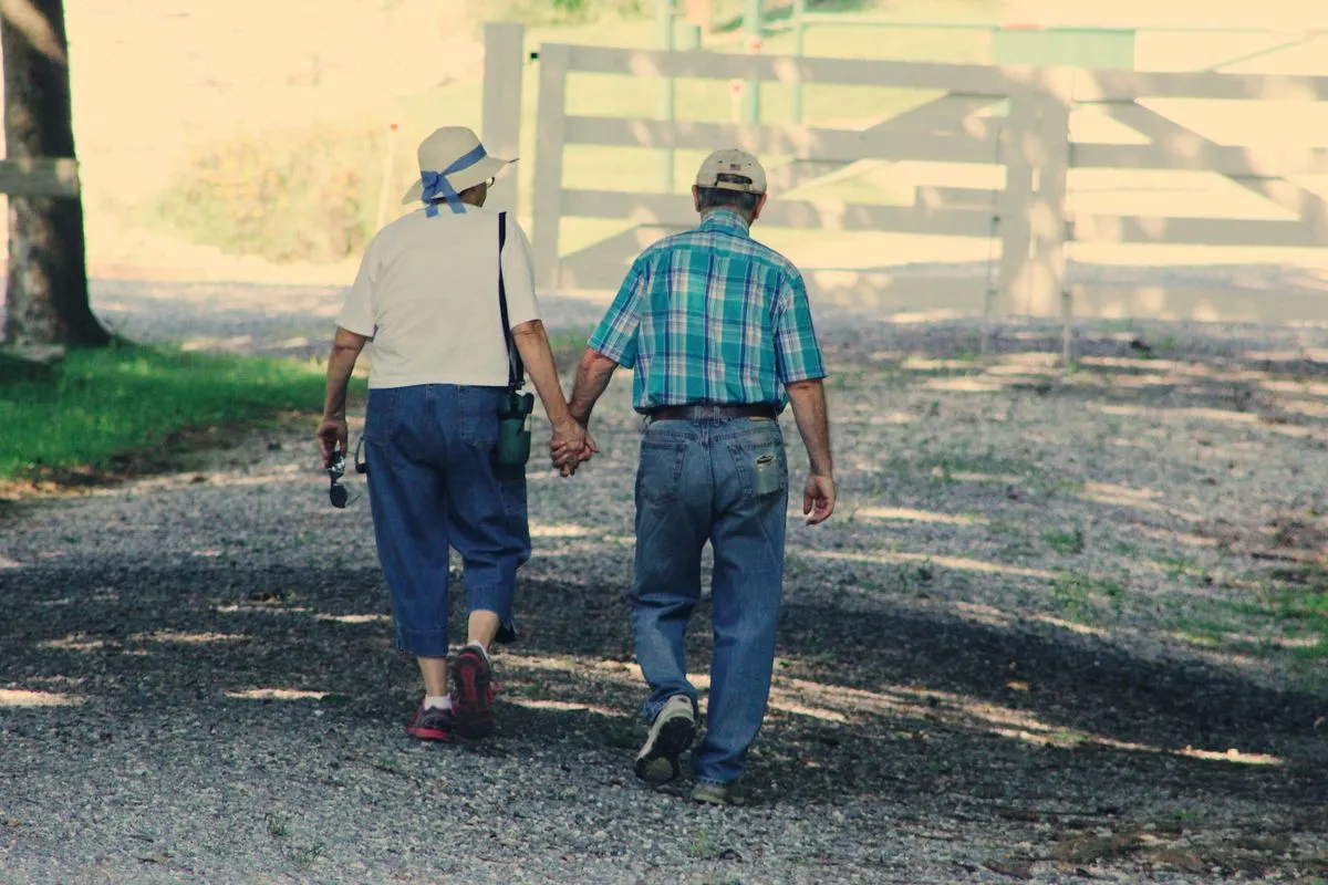 An older couple walking together outdoors