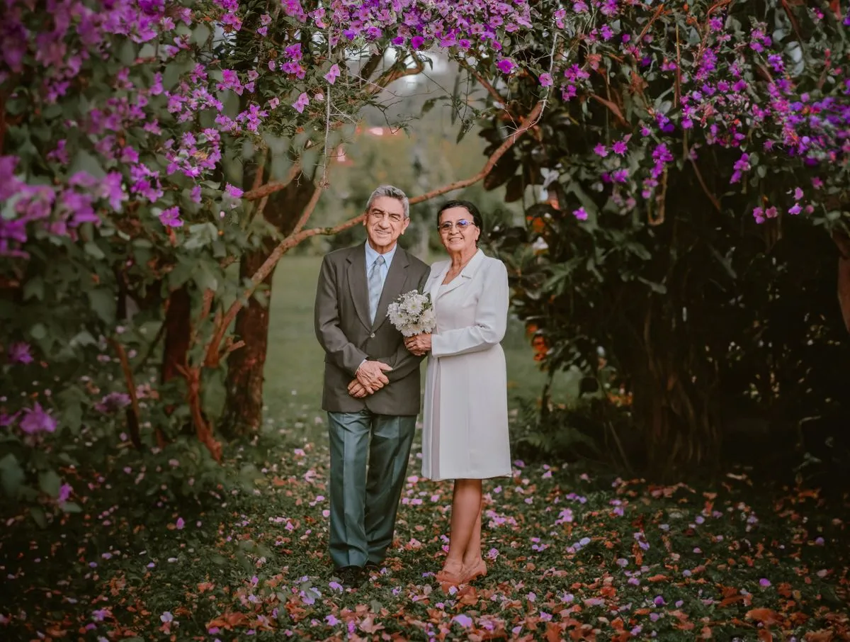An older couple standing together in a garden